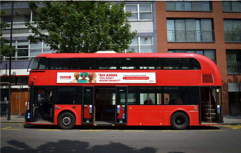 Red Double decker bus with DKMS advertising on the side